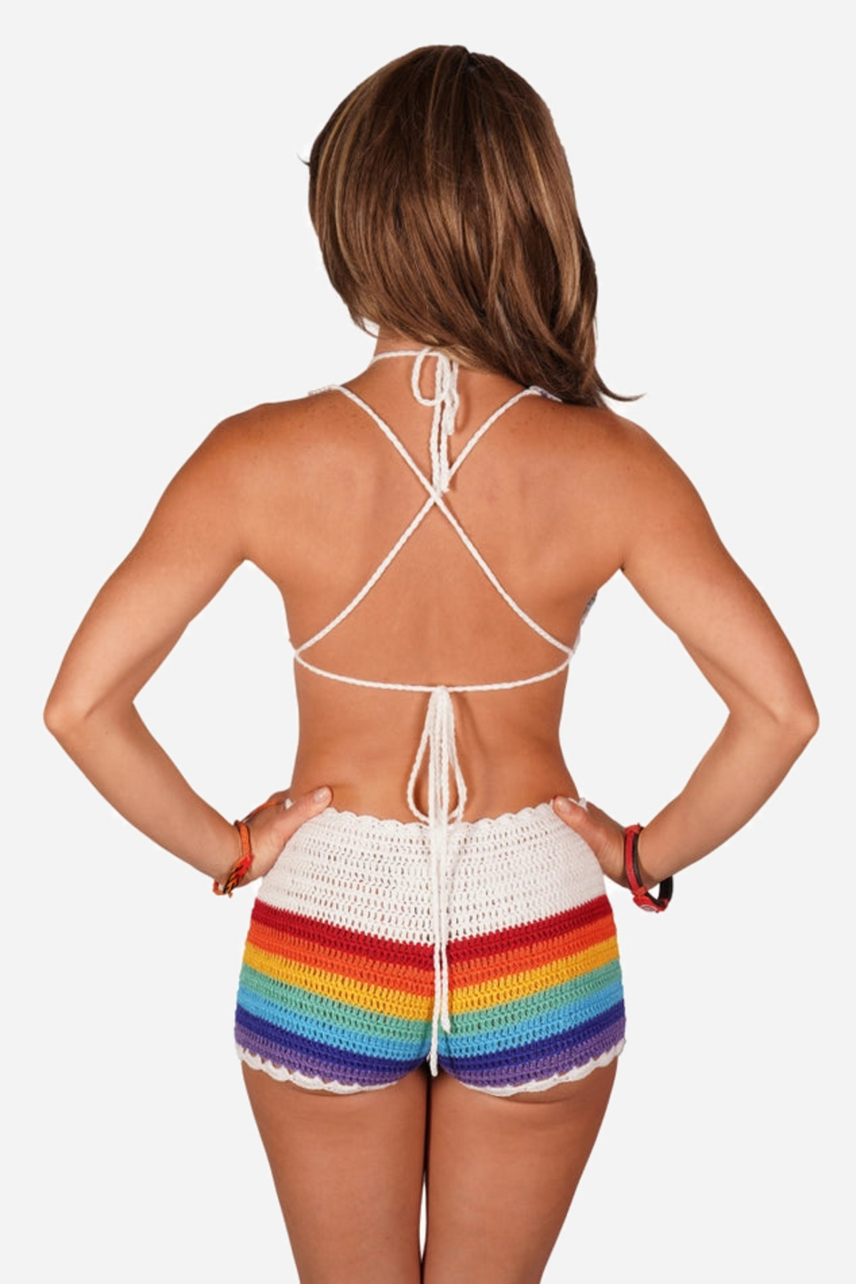 Back view of a model in the rainbow crochet butterfly top, its white halter ties crossing her bare back above matching rainbow crochet shorts.