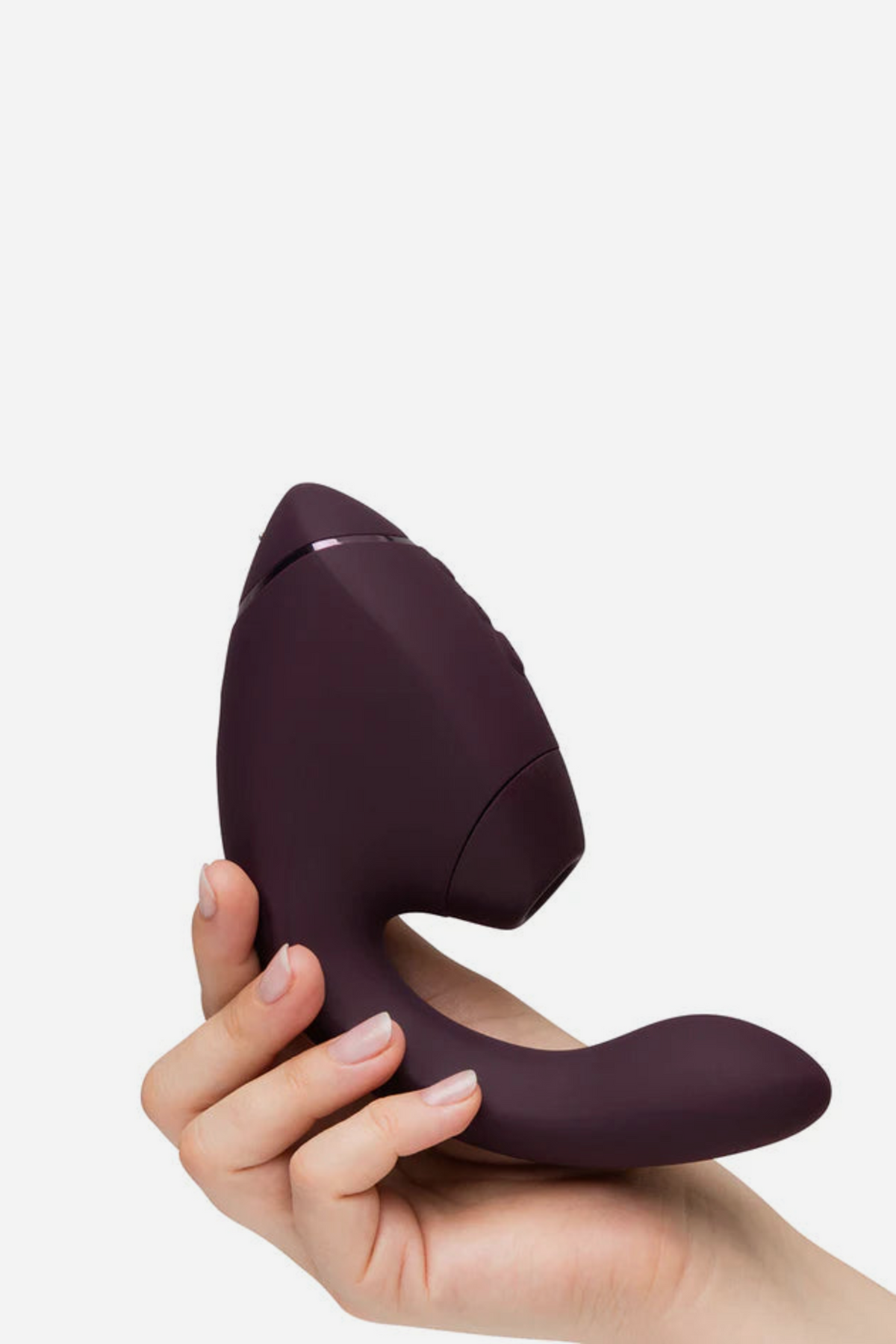 Hand holding the dark purple Womanizer Next Duo Air Pulse Rabbit Vibe, showing the size of the G-spot arm and the Pleasure Air head