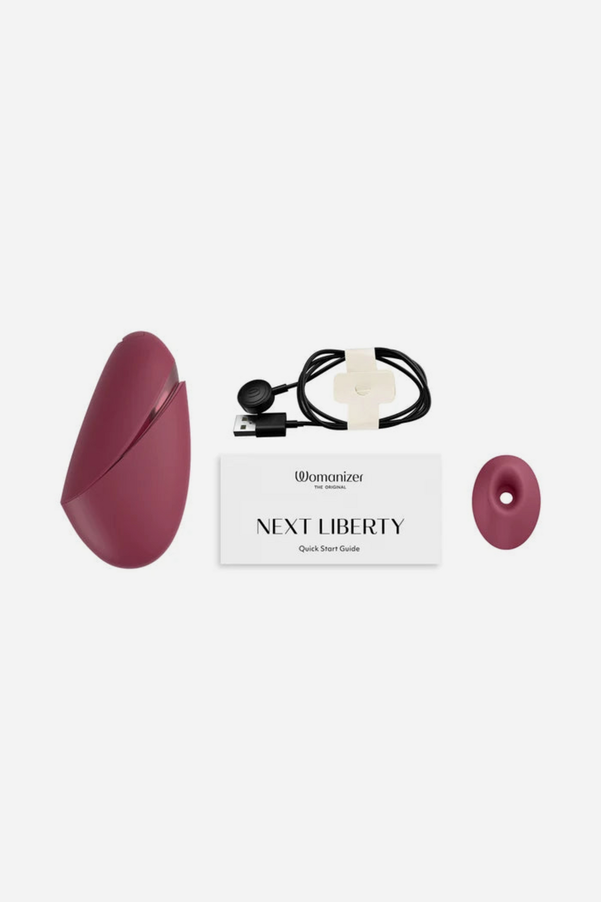 What comes with the Womanizer Liberty in Bordeaux: the stimulator, a magnetic USB charging cable, a spare silicone head and the printed guide