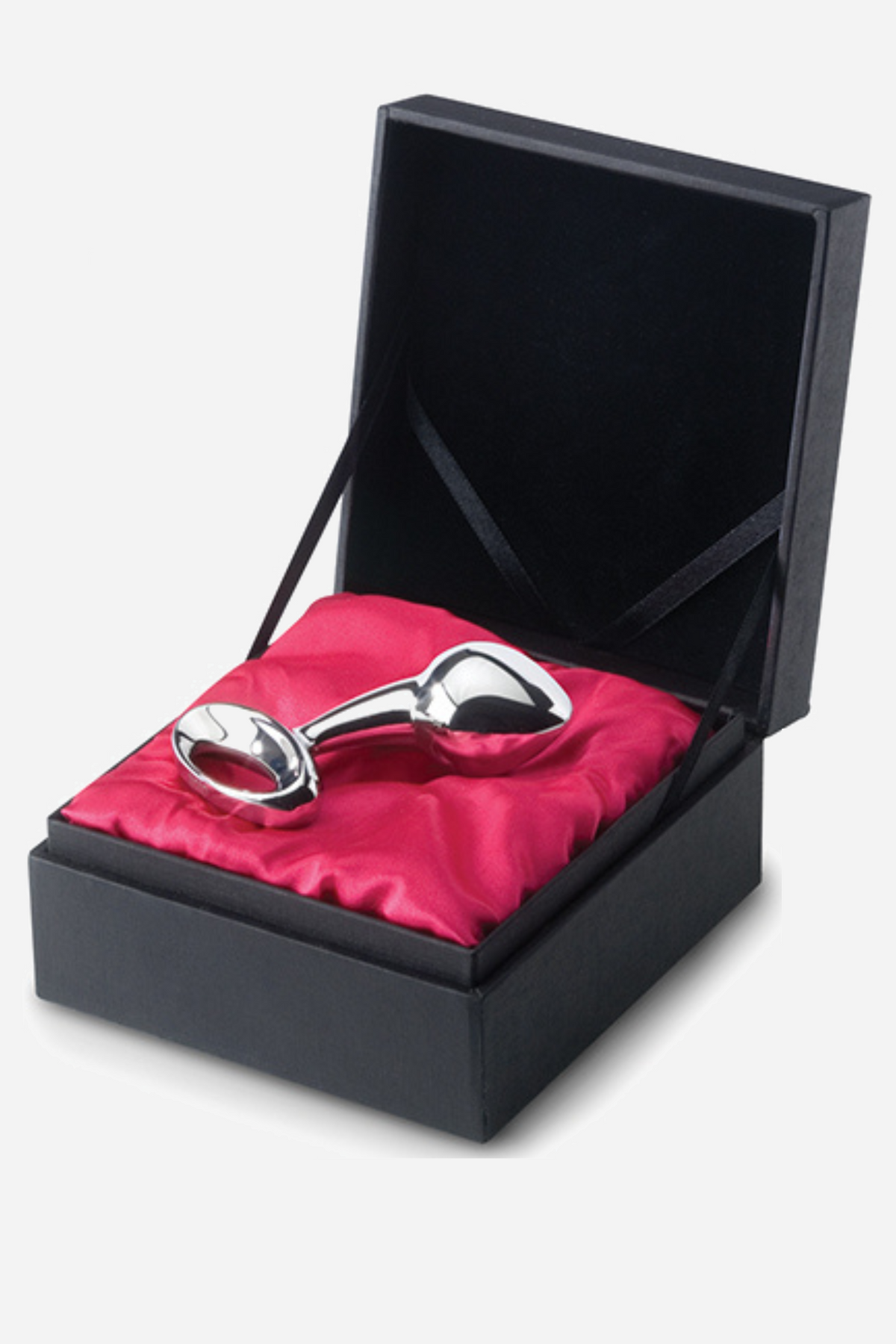 The medium njoy stainless steel plug lying in its black gift box on bright red satin, with the hinged lid standing open behind it