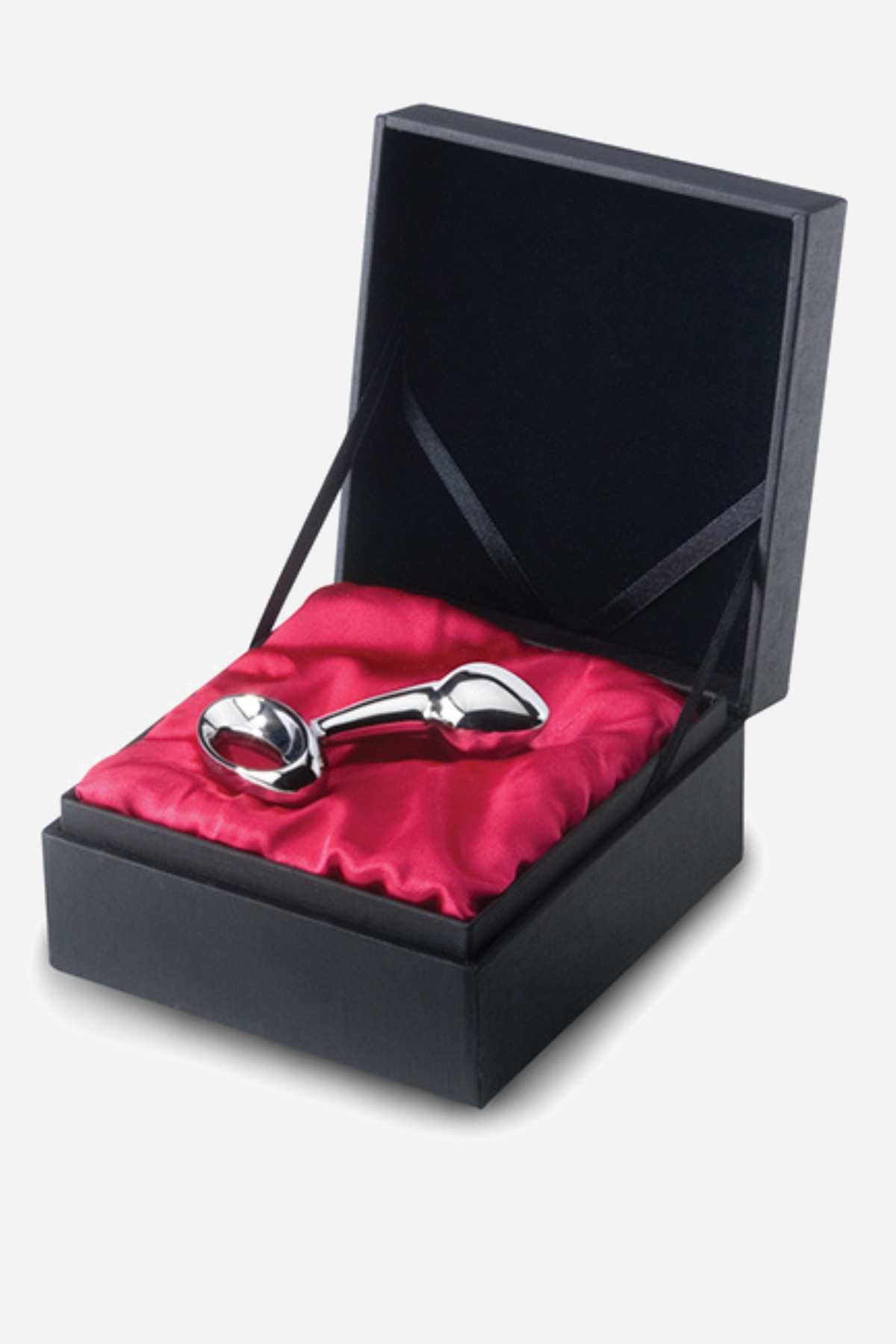The small njoy stainless steel plug lying in its black gift box on bright red satin, with the hinged lid standing open behind it