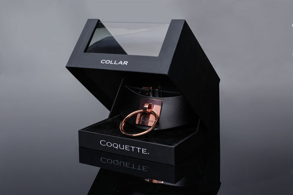 shows off the gorgeous windowed gift box housing the black and rose gold bondage collar