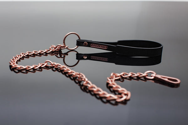 close up of the rose gold bondage leash with vegan leather wrist strap- luxury fetish accessories