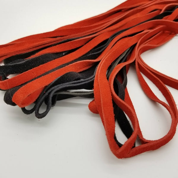 close up of the red and black suede looped flogger falls