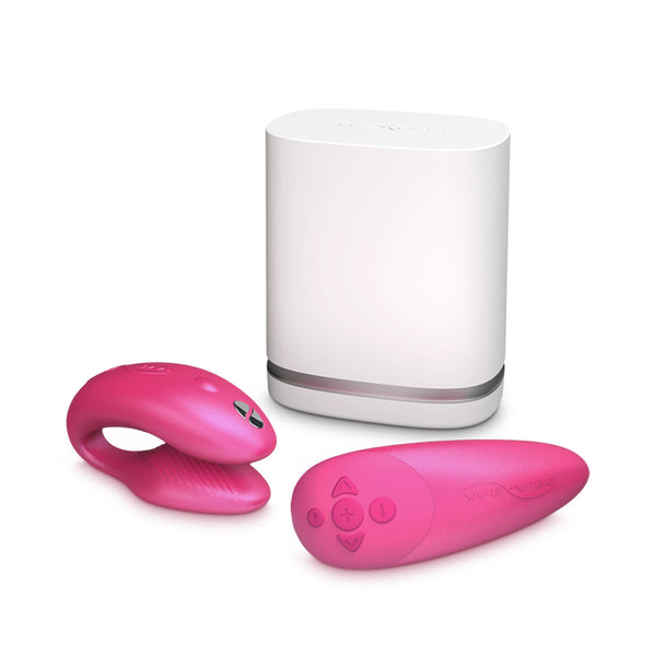 c-shaped hands-free wearable vibrator in pink with matching remote and white storage case