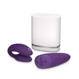 c-shaped hands-free wearable vibrator in purple with matching remote and white storage case