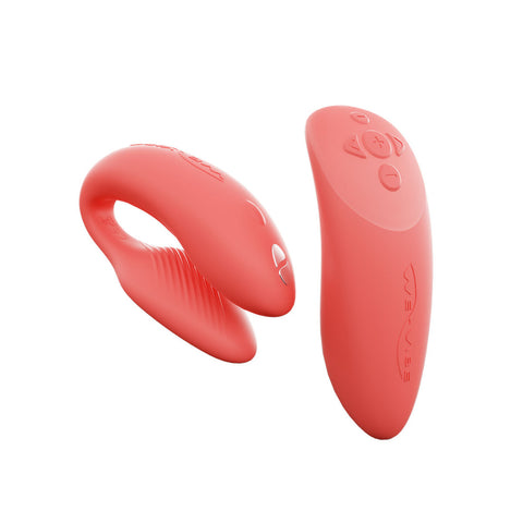 c-shaped hands-free wearable vibrator and matching color remote in coral