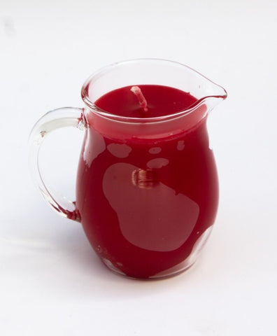 glass pitcher with pour spout filled with red paraffin wax for kinky wax play