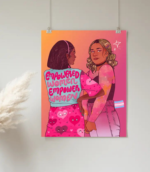 art print made by alexandria artist that shows two women. one has a shirt that says empowered women empower women and the other has a trans flag in her pocket