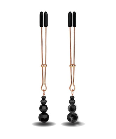 Gold tweezer style nipple clamps, often called vice clamps, with three black beads at the bottom. the nipple clamps have black rubber tips