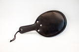 Back side of a Cushioned Leather Paddle; this side is rounded with a handle and is stiff and firm for stingy spanking