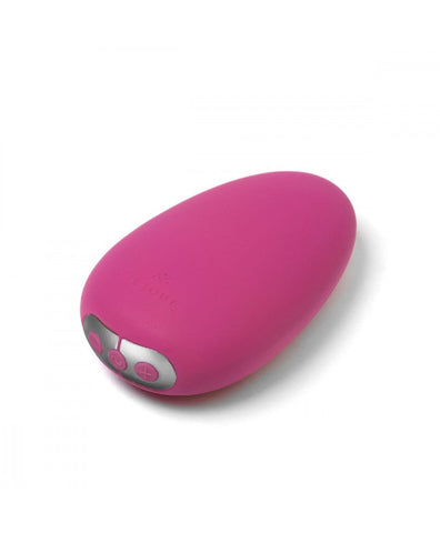 a stone sized fuchsia palm style vibrator with three buttons at the bottom of the toy