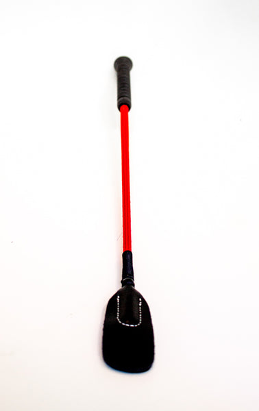 Closeup of black bdsm crop with red shaft and leather-look, thin and rounded tip crop