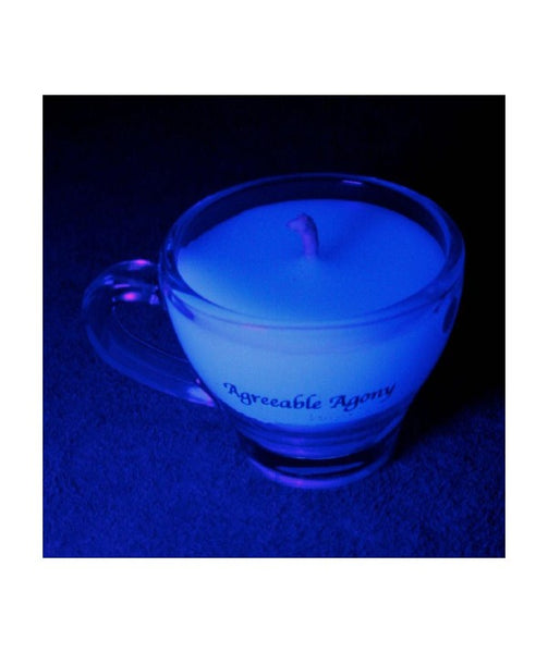 2.75oz of UV reactive kinky wax for wax play glowing in black light in glass espresso cup