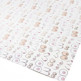 A close up of a corner of  wrapping paper with white background and boob outlines in different shapes, sizes, and colors.