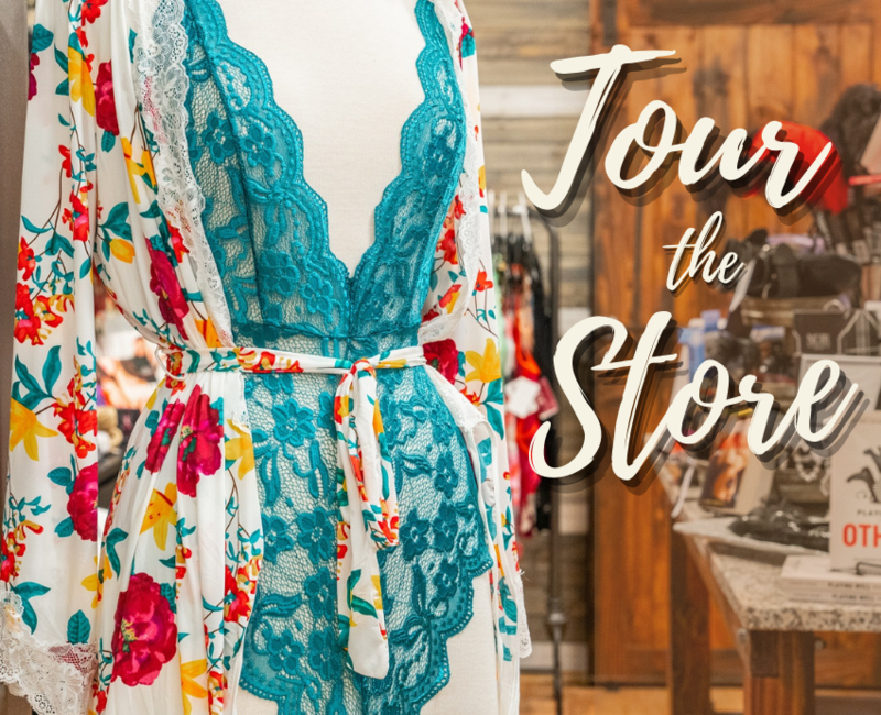 image of mannequin with teal lace lingerie and floral robe in foreground. text reads tour the store